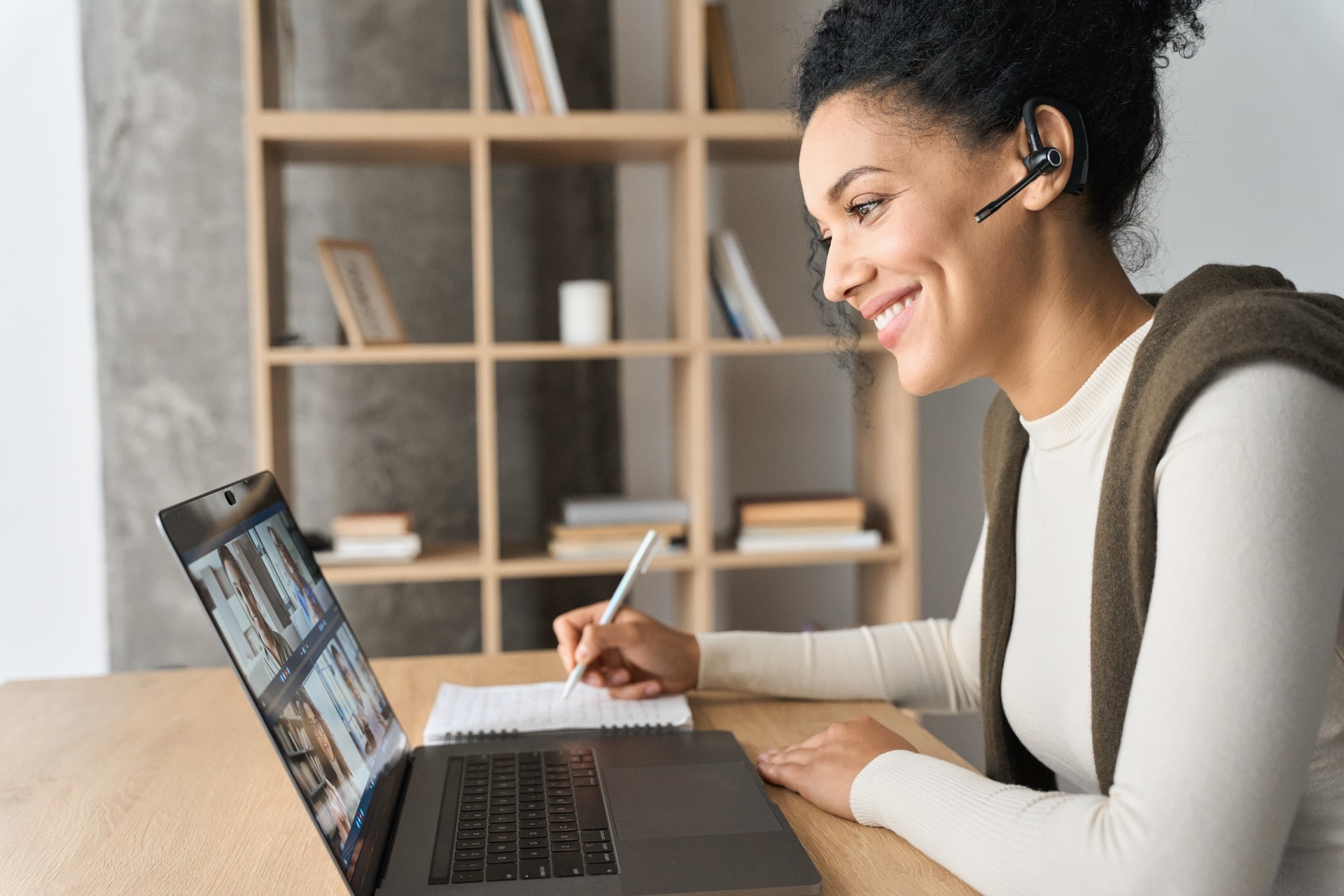 African American female student having video call videoconference on laptop.